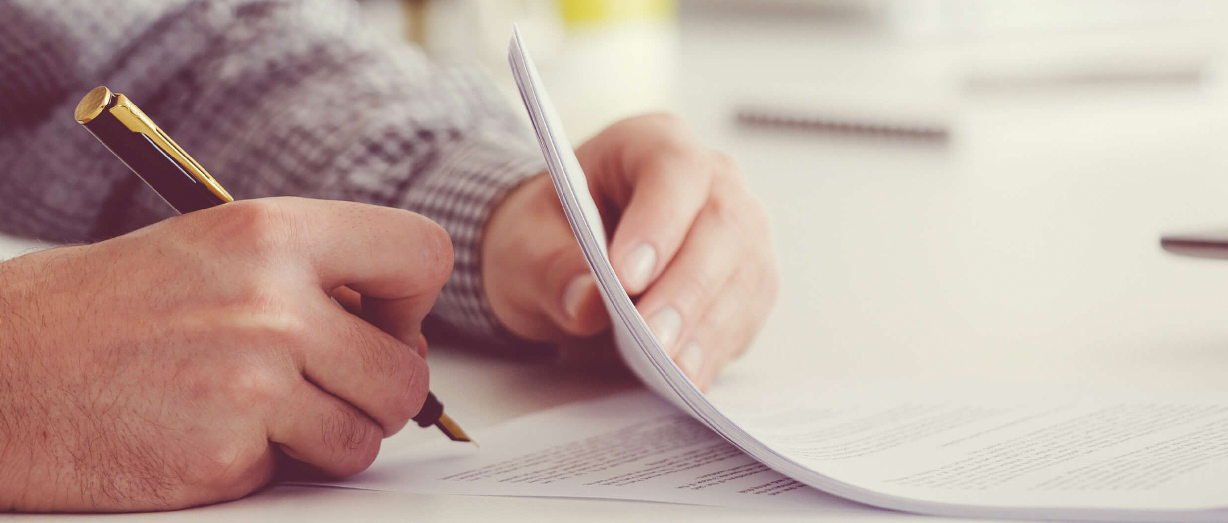 A person signing a paper