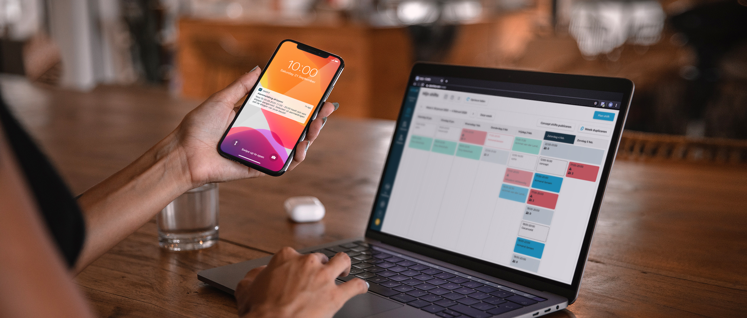 A woman using a phone and a laptop