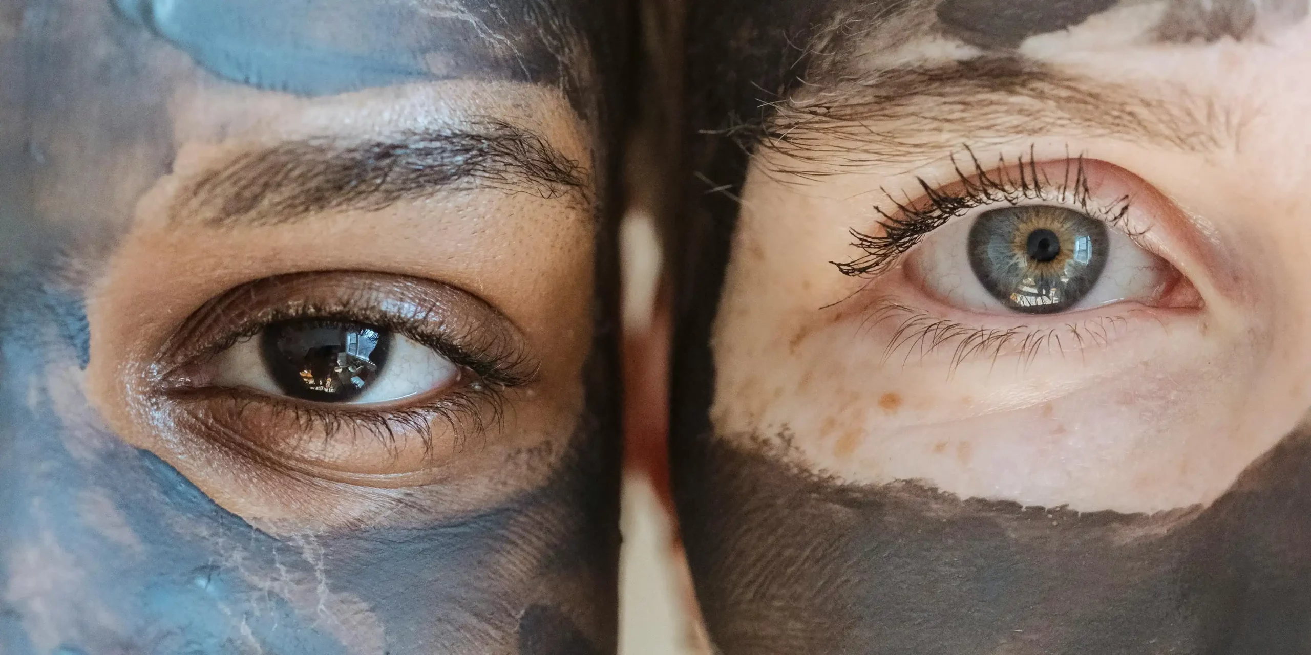 close up of two women with a mud mask on