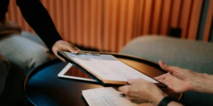 Photo of hands passing a CV to another person