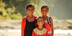 three young girls smiling to the camera