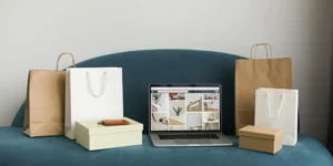 Carton boxes and bags on the sofa with the laptop