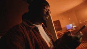 man holding his smartphone in his living room