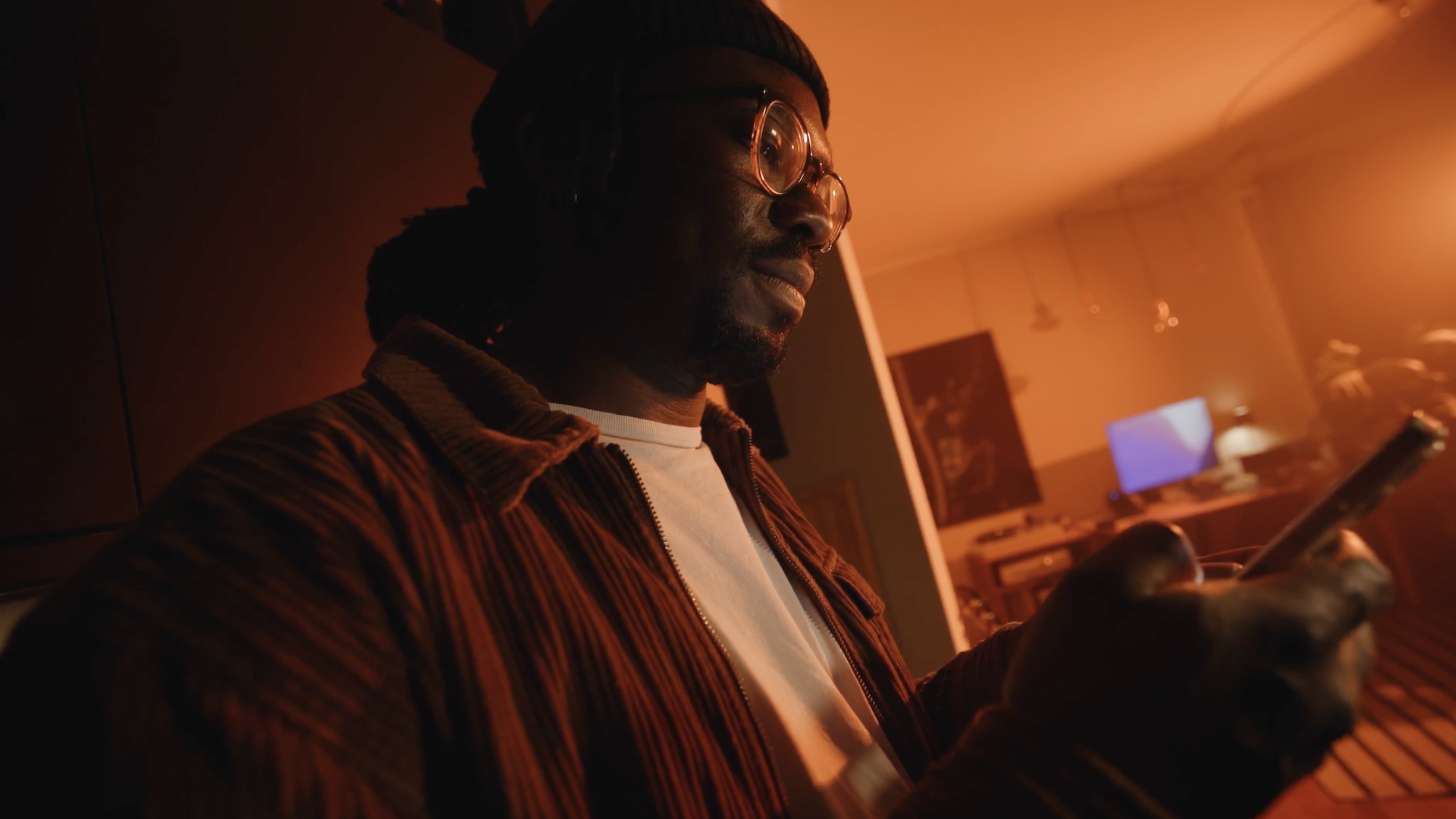 man holding his smartphone in his living room