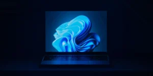 Laptop in blue light showing abstract blue shape