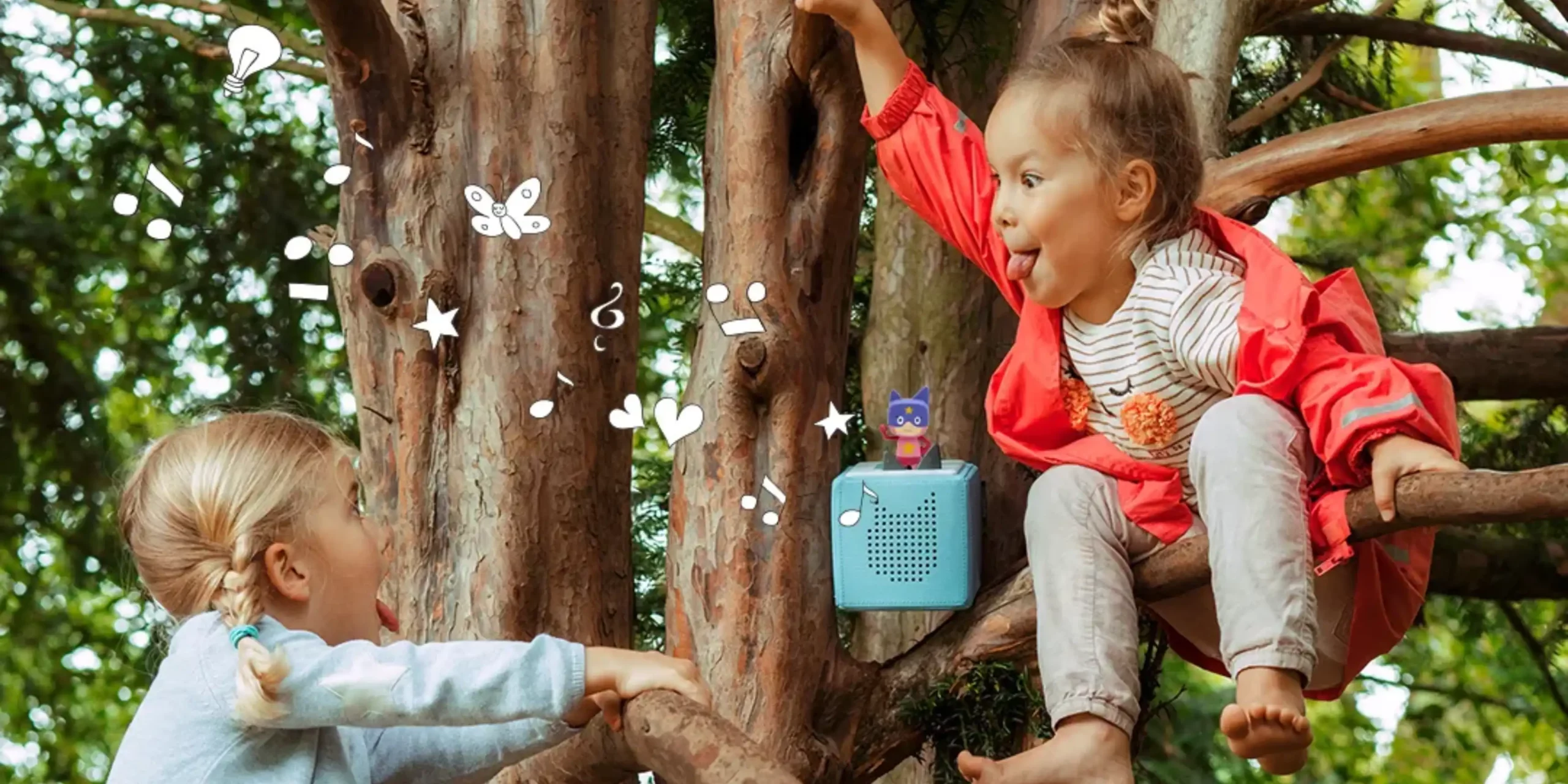 Tonies lifestyle image - two kids on a tree playing