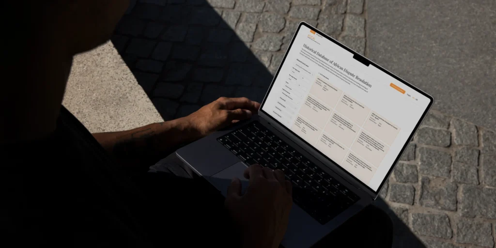 Person holding a laptop with ICCA website