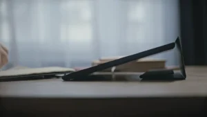 Aged person's hands touching tablet's screen