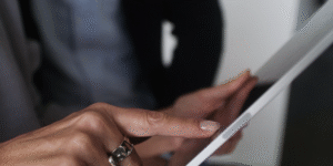 Woman's hand touching an Ipad's screen