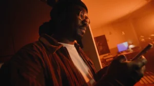 Young man in the living room looking at his phone's screen