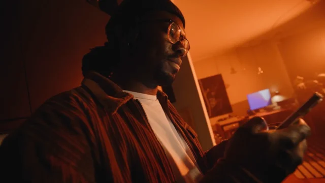 Young man in the living room looking at his phone's screen