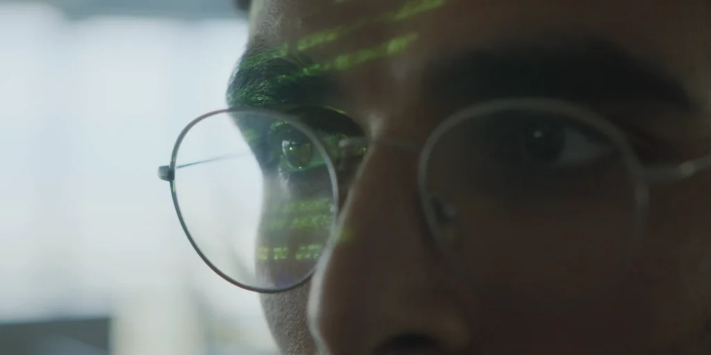 man with glasses looking at screen close-up