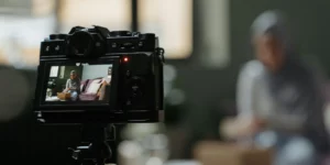Photo of a person being filmed with a DSLR
