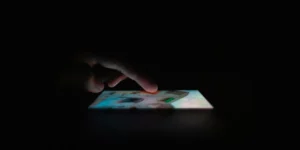 smartphone screen popping out of dark background