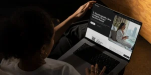 Woman is holding laptop with the DingDone website