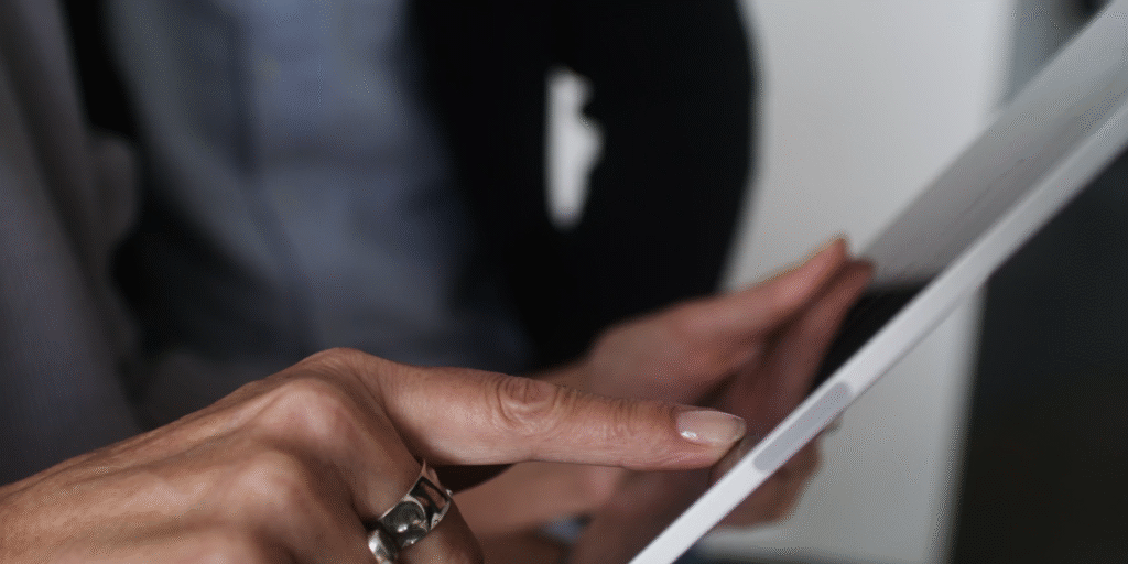 Woman's hand touching an Ipad's screen
