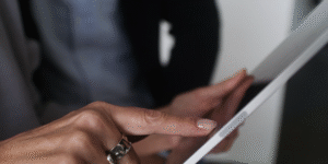 Woman's hand touching an Ipad's screen
