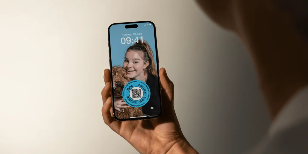 person holding a phone with a thnx tags screensaver