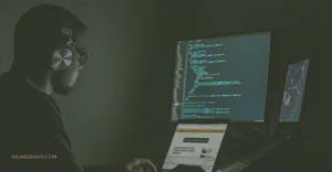A developer coding in a black room